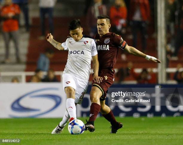 Maximiliano Velazquez of Lanus fights for the ball with Domingo Blanco of Independiente during a match between Independiente and Lanus as part of the...