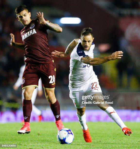 Juan Manuel Martinez of Independiente fights for the ball with Leandro Maciel of Lanus during a match between Independiente and Lanus as part of the...