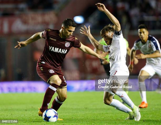 Ivan Marcone of Lanus fights for the ball with Nicolas Tagliafico of Independiente during a match between Independiente and Lanus as part of the...