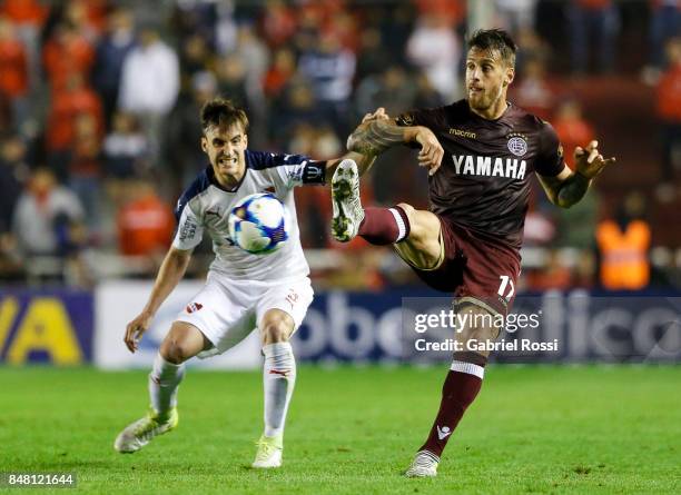 German Denis of Lanus fights for the ball with Nicolas Tagliafico of Independiente during a match between Independiente and Lanus as part of the...