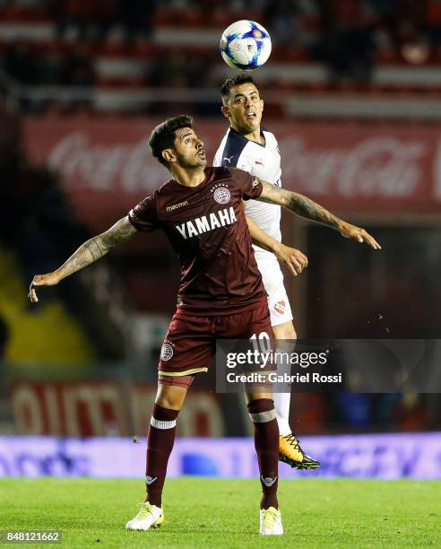 Roman Martinez of Lanus fights for the ball with Diego Rodriguez of Independiente during a match between Independiente and Lanus as part of the...