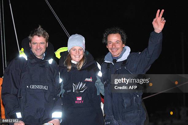 French skipper Marc Guillemot celebrates after crossing the finish line of the round-the-world solo sailing race on February 16 in the western-French...