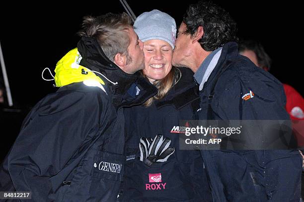 French skipper Marc Guillemot Marc Guillemot and Yann Elies kiss Samantha Davis after crossing the finish line of the round-the-world solo sailing...