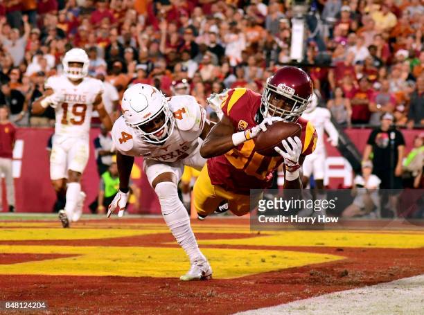 Deontay Burnett of the USC Trojans makes a catch for a touchdown in front of DeShon Elliott of the Texas Longhorns to take a 7-0 lead during the...