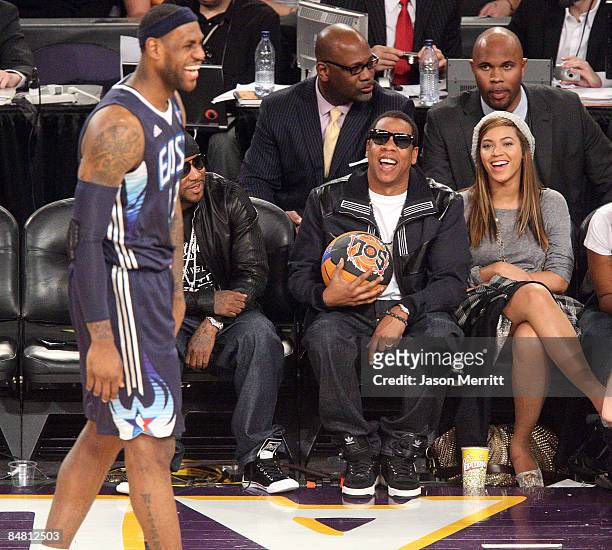 LeBron James of the Eastern Conference team, rapper Jay-Z, and singer Beyonce Knowles laugh during the 58th NBA All-Star Game, part of 2009 NBA...