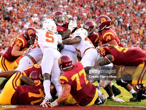 Ronald Jones II of the USC Trojans is stopped by the Texas Longhorns defense at the goal line during the first quarter at Los Angeles Memorial...