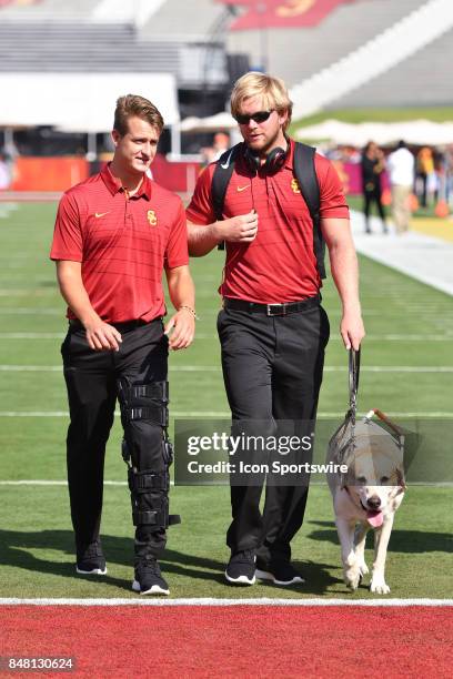 Michael Brown and USC Jake Olson with his guide dog, Quebec, before a college football game between the Texas Longhorns and the USC Trojans on...