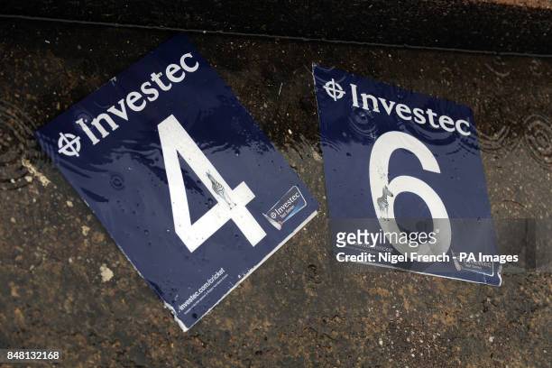 Discarded 'Four' and 'Six' signs lie in a puddle as rain continues to fall at Edgbaston
