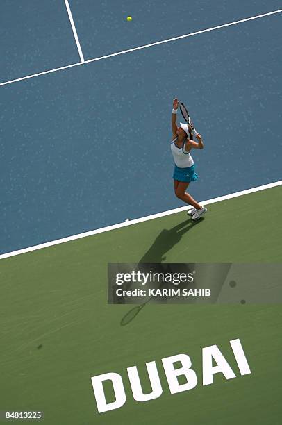 Petra Kvitova of the Czech Republic serves the ball to Germany's Julia Schruff during their singles tennis match on the first day of the WTA Dubai...