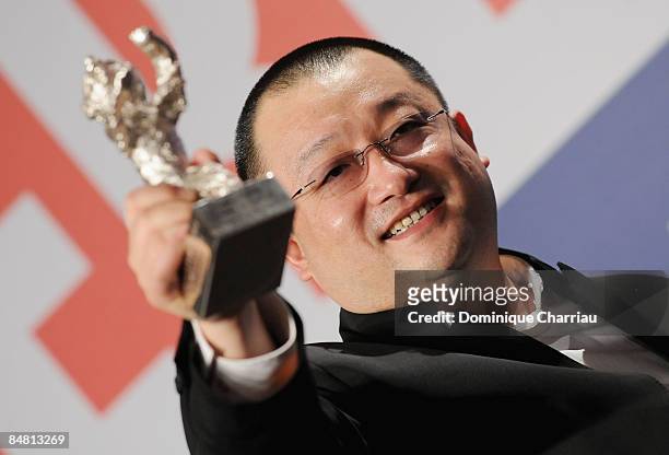 Wang Xiaoshuai poses with the Silver Bear for the Best Script for the film In Love We Trust attends the 'Award Winners Press Conference' as part of...