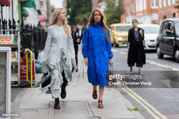 Jeanette Madsen wearing a ruffled dress and Emili Sindlev wearing a brown JW Anderson bag with fringes, blue dress outside JW Anderson during London...