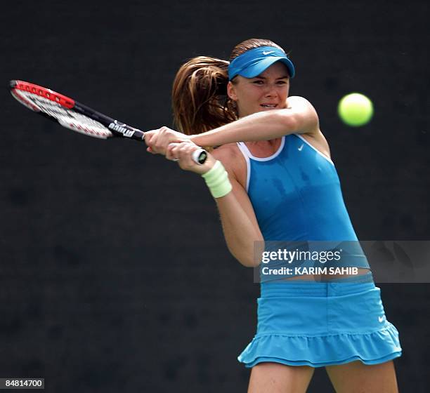 Slovakia's Daniela Hantuchova returns the ball to Switzerland's Stefanie Voegele during their singles tennis match on the second day of the WTA Dubai...