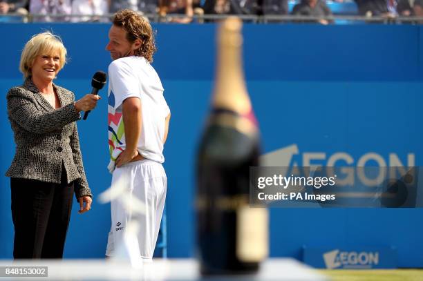 S Sue Barker speaks to Argentina's David Nalbandian after being disqualified from the Final for kicking an advertising board and causing an injury to...