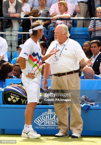 Argentina's David Nalbandian talks to ATP's Tom Barnes after being disqualified from the Final for an advertising board and causing an injury to line...