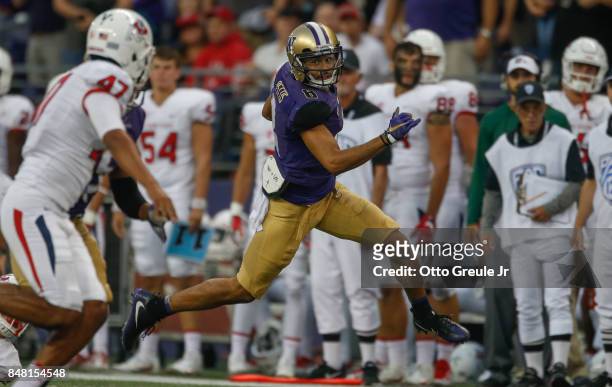 Wide receiver Dante Pettis of the Washington Huskies returns a punt for a touchdown against the Fresno State Bulldogs at Husky Stadium on September...