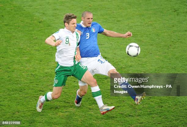 Republic of Ireland's Kevin Doyle battes for the ball with Italy's Giorgio Chiellini