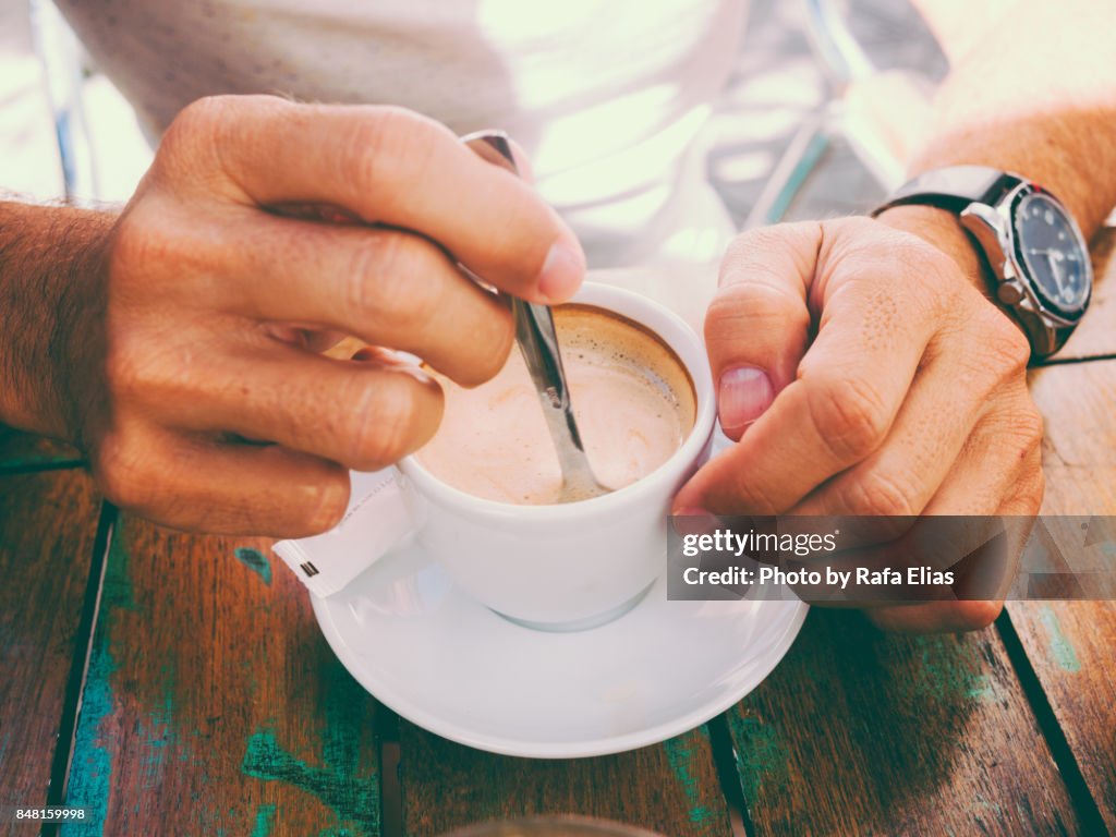 Hand stirring coffee