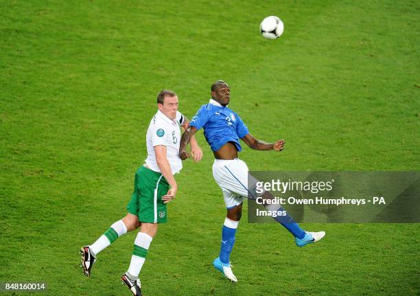 Italy's Mario Balotelli and Republic of Ireland's Richard Dunne battle for the ball