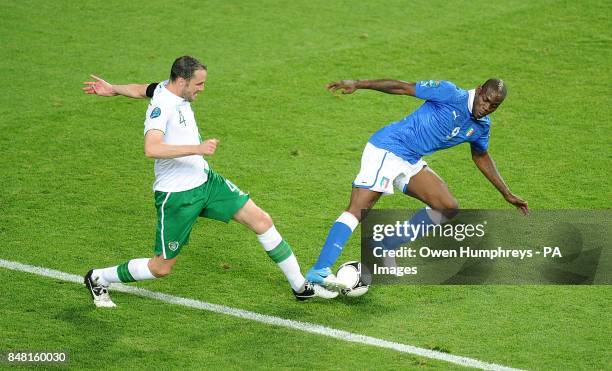Rep of Ireland's John O'Shea and Italy's Mario Balotelli battle for the ball