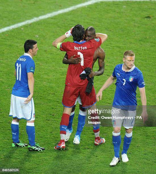 Italy's Mario Balotelli and goalkeeper Gianluigi Buffon embrace after the final whistle