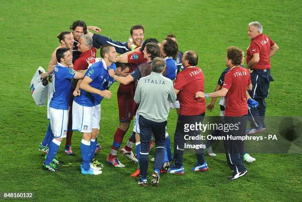 The Italy players and staff celebrate after the final whistle