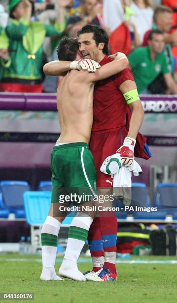Italy captain Gianluigi Buffon hugs Republic of Ireland's Sean St Ledger during the UEFA Euro 2012 Group match at the Municipal Stadium, Poznan,...