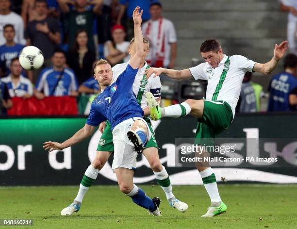 Republic of Ireland's Robbie Keane clears under pressure from Italy's Ignazio Abate during the UEFA Euro 2012 Group match at the Municipal Stadium,...
