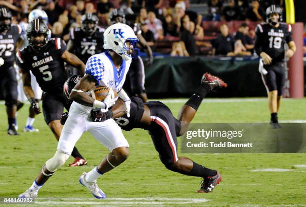 Defensive back Derrick Baity of the Kentucky Wildcats intercepts a pass intended for wide receiver OrTre Smith of the South Carolina Gamecocks at...