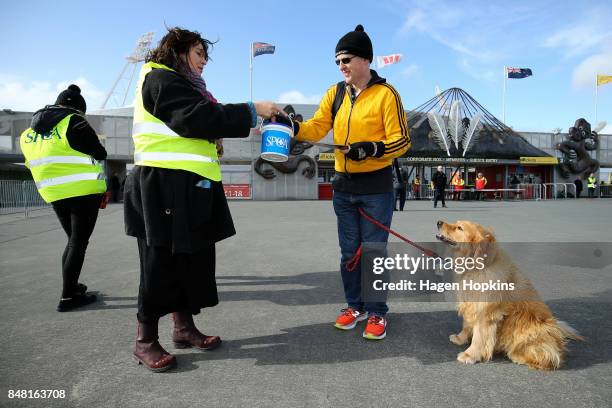 Dog owner gives a donation to SPCA as part of the 'Bark in the Park' event during the round five Mitre 10 Cup match between Wellington and Canterbury...