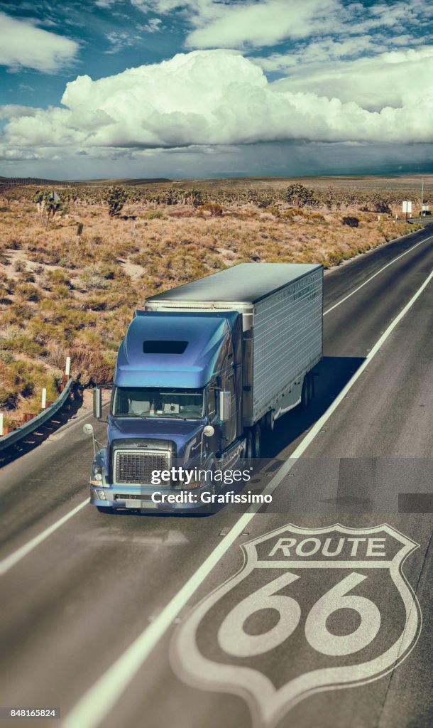 Blue truck driving through Southwest USA on route 66