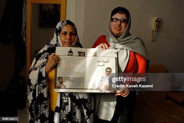 Ameneh Bahrami and her mother stand holding a magazine with her story published inside. Ameneh Bahrami was blinded by Majid Movahedi in an acid...