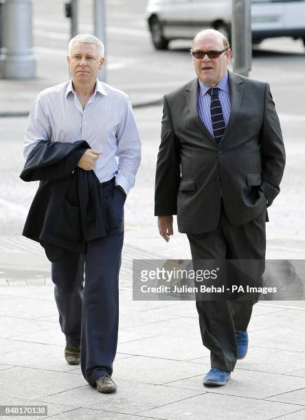 Bass guitarist Adam Clayton arrives with U2 manager Paul McGuinness at Dublin Circuit Criminal Court, where his former personal assistant, Carol...