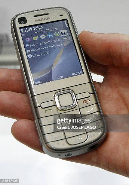 Hand holds Nokia's new model 6720 classic, on show at the Mobile World Congress in Barcelona on February 16, 2009. Samsung unveiled the world's first...