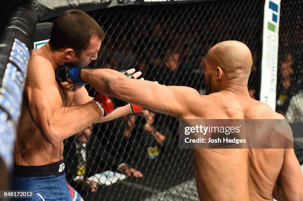 David Branch punches Luke Rockhold in their middleweight bout during the UFC Fight Night event inside the PPG Paints Arena on September 16, 2017 in...