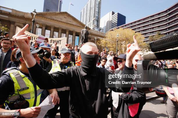 Masked protestor is detained by police as they enforce laws surrounding the wearing of masks to cover the face at rallies on September 17, 2017 in...