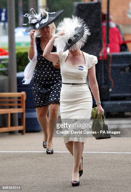 Ladies hold on to their hats in the wind and rain during day four of the 2012 Royal Ascot meeting at Ascot Racecourse, Berkshire.