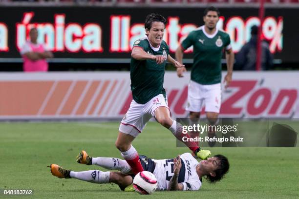 Carlos Fierro of Chivas fights for the ball with Alan Mozo of Pumas during the 9th round match between Chivas and Pumas UNAM as part of the Torneo...