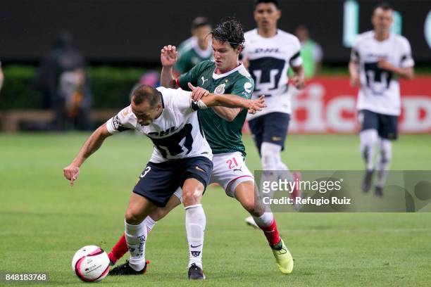 Carlos Fierro of Chivas fights for the ball with Marcelo Diaz of Pumas during the 9th round match between Chivas and Pumas UNAM as part of the Torneo...