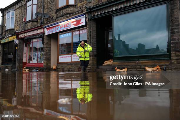 Floodwaters surrounds local shops in the centre of Mytholmroyd near Huddersfield, West Yorkshire, after torrential downpours brought flooding to...