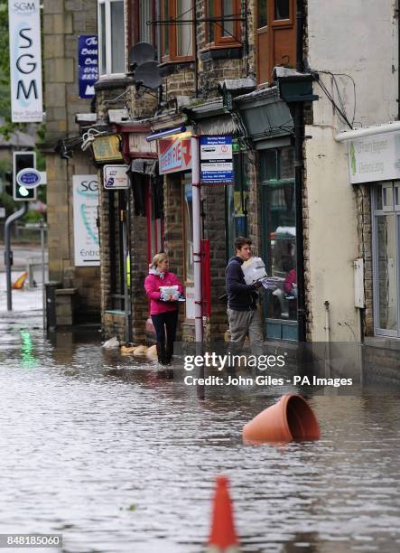 Floodwaters surrounds local shops in the centre of Mytholmroyd near Huddersfield, West Yorkshire, after torrential downpours brought flooding to...