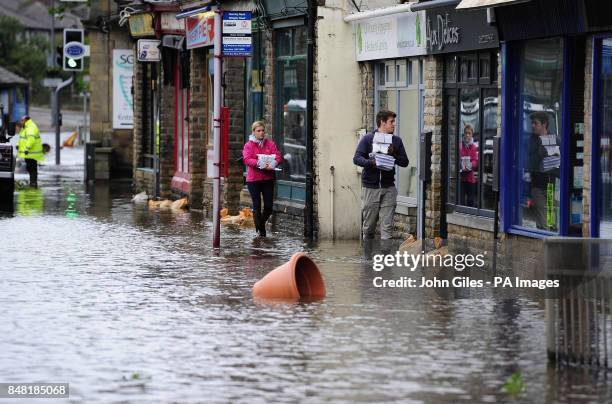 Floodwaters surrounds local shops in the centre of Mytholmroyd near Huddersfield, West Yorkshire, after torrential downpours brought flooding to...