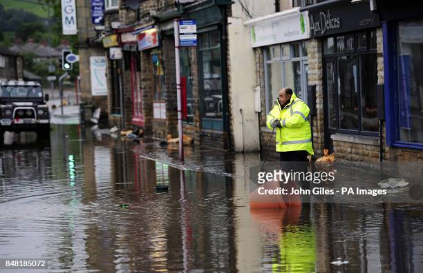 Floodwaters surrounds local shops in the centre of Mytholmroyd near Huddersfield, West Yorkshire, after torrential downpours brought flooding to...