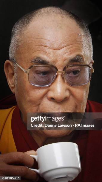 The Dalai Lama drinks tea during his visit to Blair Castle in Perthshire during his two-day tour of Scotland.
