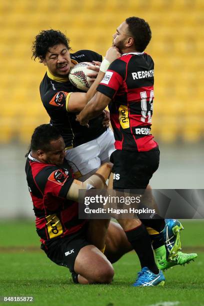 Ben Lam of Wellington is tackled by Inga Finau and Siate Tokolahi of Canterbury during the round five Mitre 10 Cup match between Wellington and...