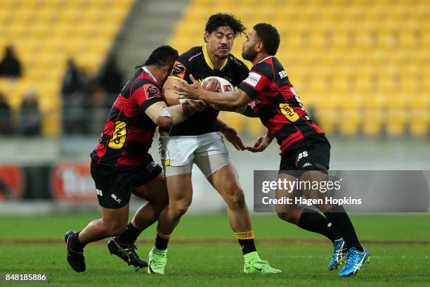 Ben Lam of Wellington is tackled by Inga Finau and Siate Tokolahi of Canterbury during the round five Mitre 10 Cup match between Wellington and...