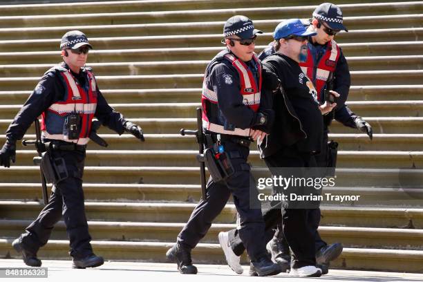 Man is detained by police on September 17, 2017 in Melbourne, Australia. Left-wing group Campaign Against Racism and Fascism organised a rally to...