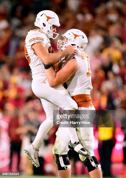 Joshua Rowland of the Texas Longhorns celebrates his field goal with Garrett Thomas to trail 14-10 to the USC Trojans during the third quarter at Los...