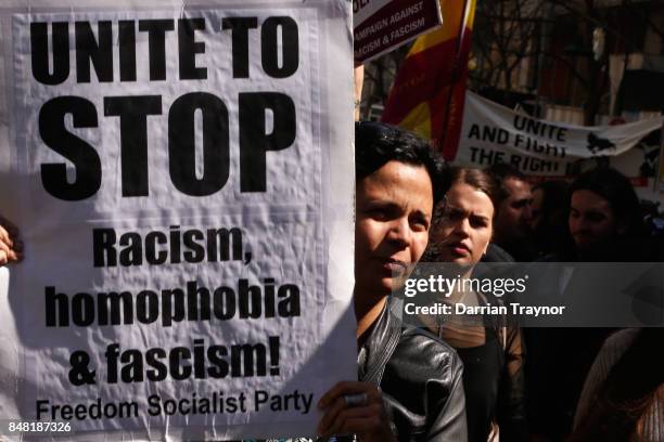 Left wing protesters hold up signs on September 17, 2017 in Melbourne, Australia. Left-wing group Campaign Against Racism and Fascism organised a...