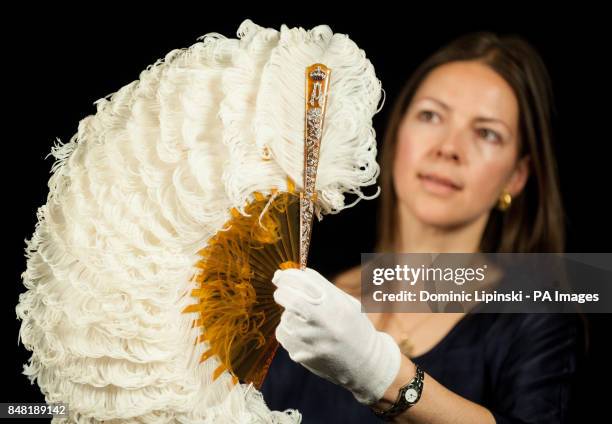 Exhibition Curator Caroline de Guitaut holds a diamond-set Coronation Fan, made for Queen Alexandra at the time of the coronation in 1902, part of...