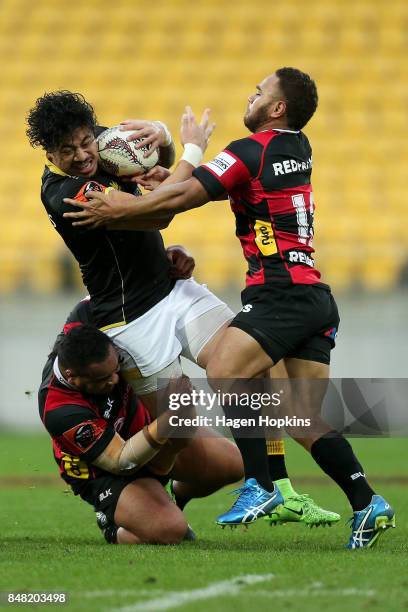 Ben Lam of Wellington is tackled by Inga Finau and Siate Tokolahi of Canterbury during the round five Mitre 10 Cup match between Wellington and...